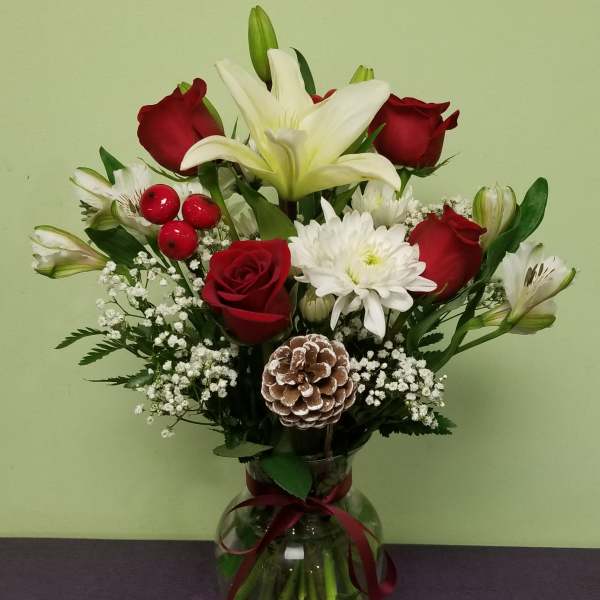 Bouquet of red roses and white lilies in a glass vase