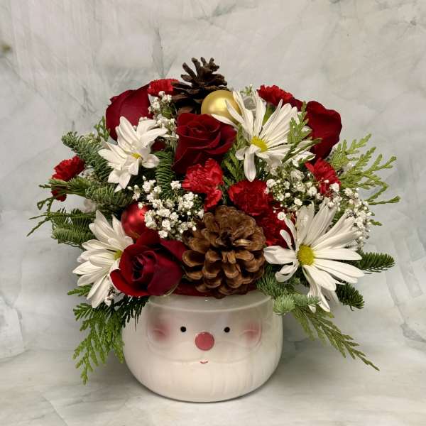 Holiday bouquet in a Santa face container with red roses and white daisies