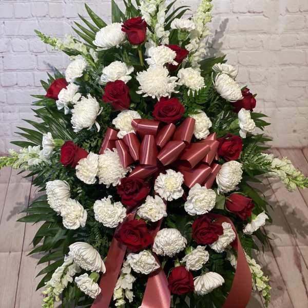 Large red and white floral spray with ribbon bow