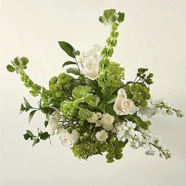 Green and white floral arrangement with roses and tall spiky blooms