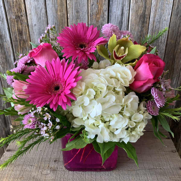 Pink and white mixed bouquet in a magenta vase