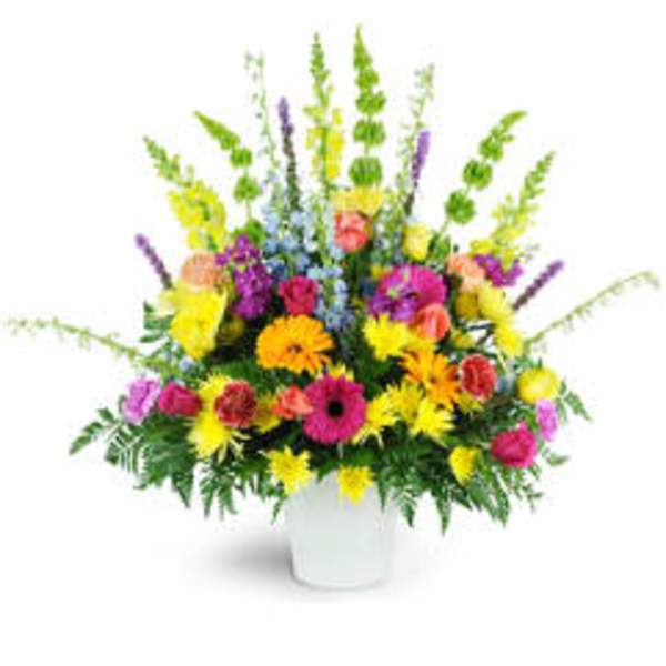 Colorful mixed flower arrangement in a white vase