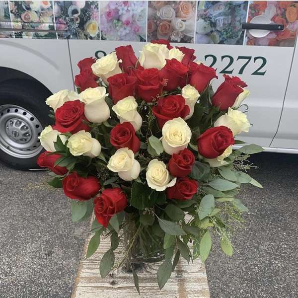 Bouquet of red and white roses in a glass vase