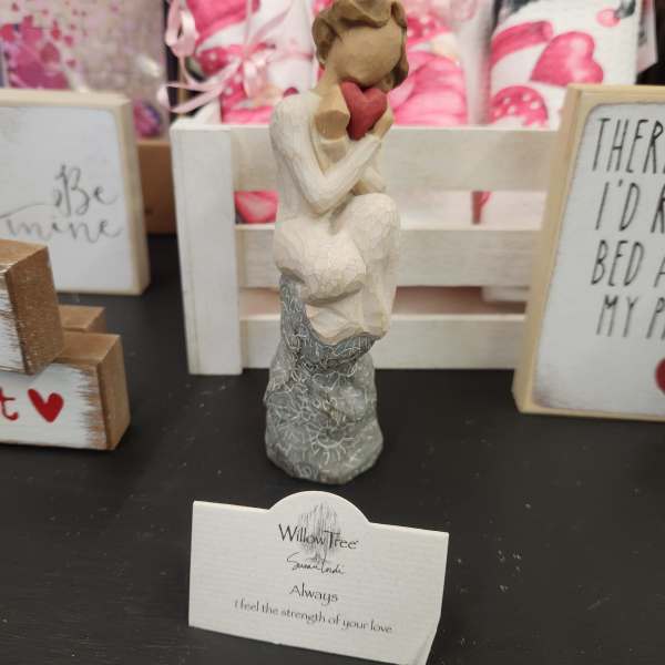 Small Willow Tree figurine of a seated figure holding a red heart