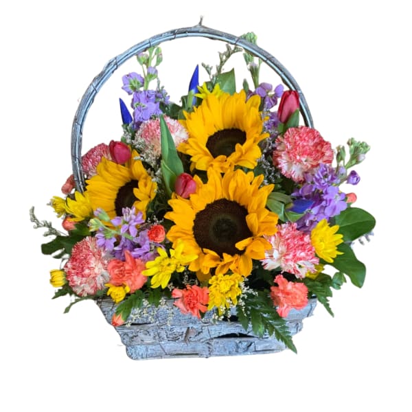 Basket arrangement with sunflowers, carnations, and purple flowers