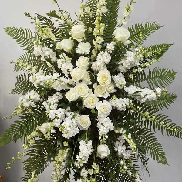 White rose and stock standing spray with fern foliage