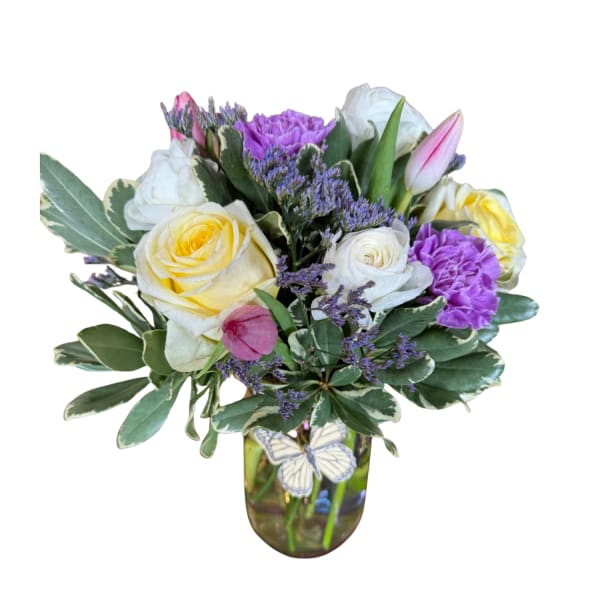 Bouquet of yellow and white roses in a glass vase