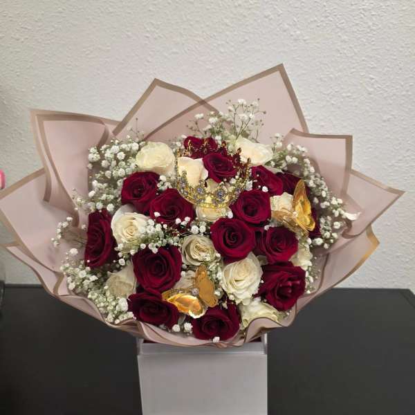 Bouquet of red and white roses with baby’s breath and butterfly accents