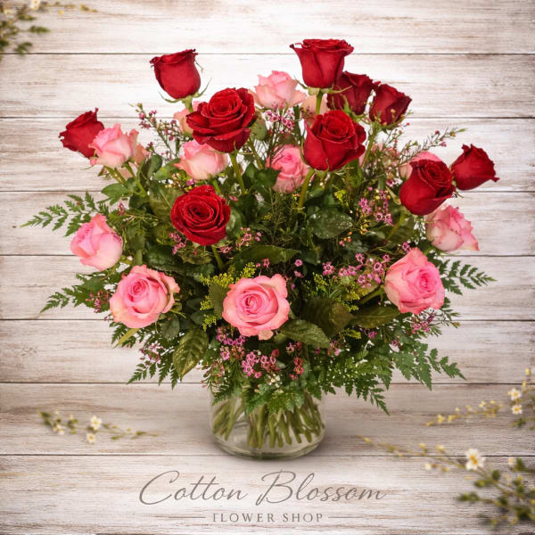 Bouquet of red and pink roses in a clear glass vase