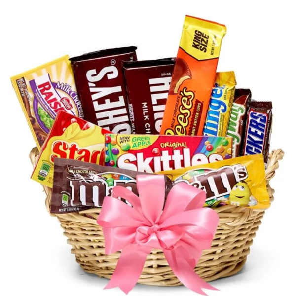 Basket of assorted candy bars and chocolates with a pink bow