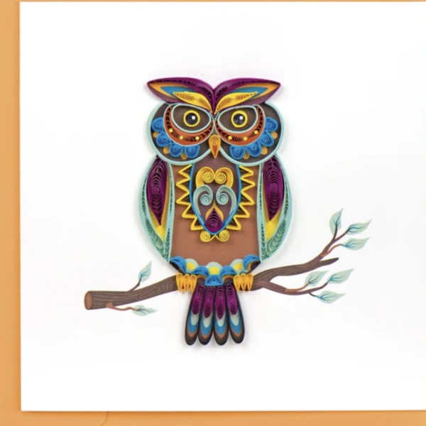 Colorful quilled owl perched on a branch against a white background