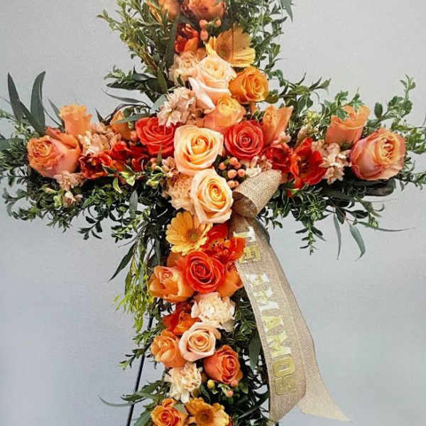 Orange and peach floral cross with roses and gerbera daisies