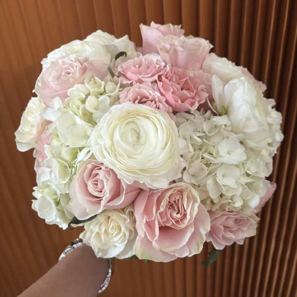 Round bouquet of pale pink and white roses with hydrangeas