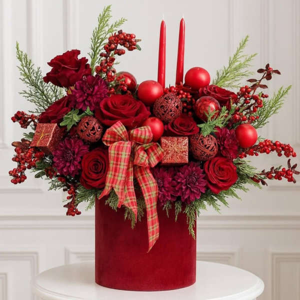 Red roses and candles in a velvet box with a plaid bow