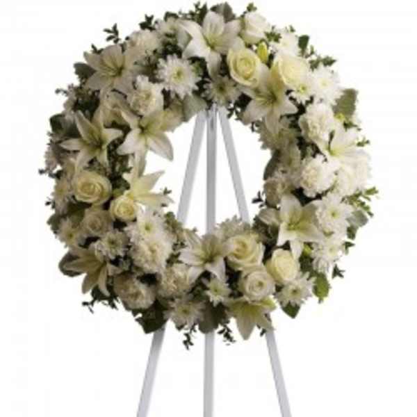 White floral wreath on a standing easel