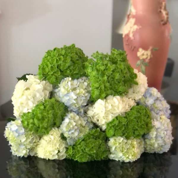 Clustered hydrangea arrangement in green, white, and pale blue