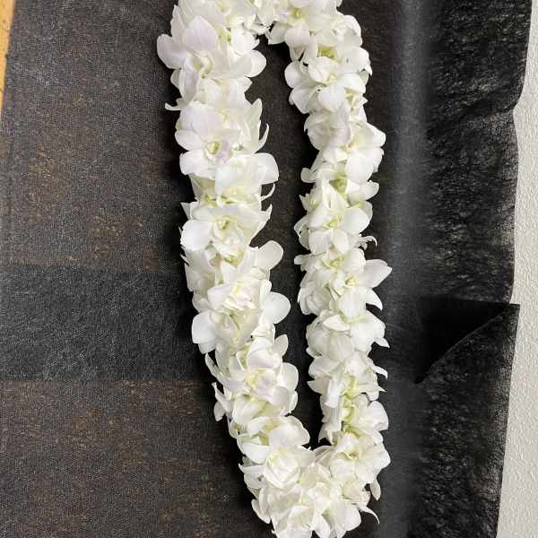 White flower lei on black fabric