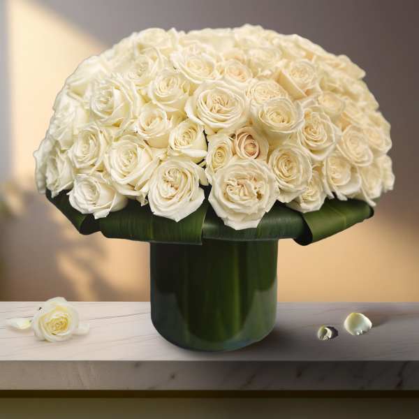 White rose bouquet in a dark green vase