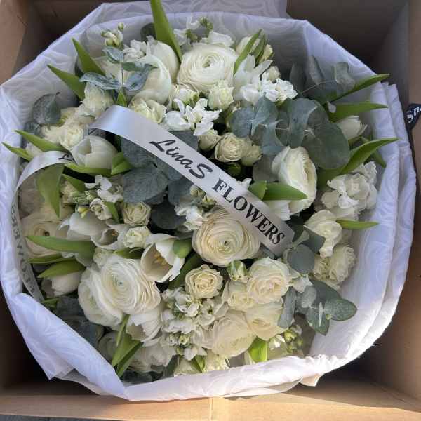 White bouquet with roses and ranunculus in a box