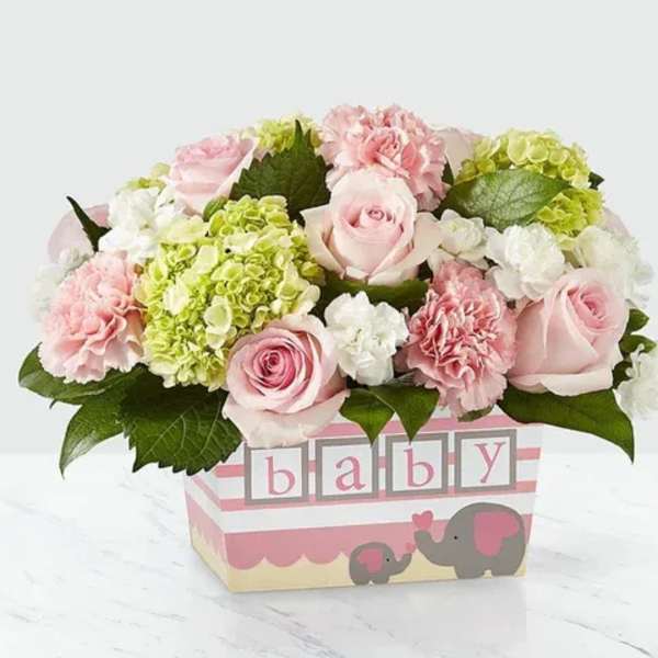Pink roses and carnations in a baby-themed box
