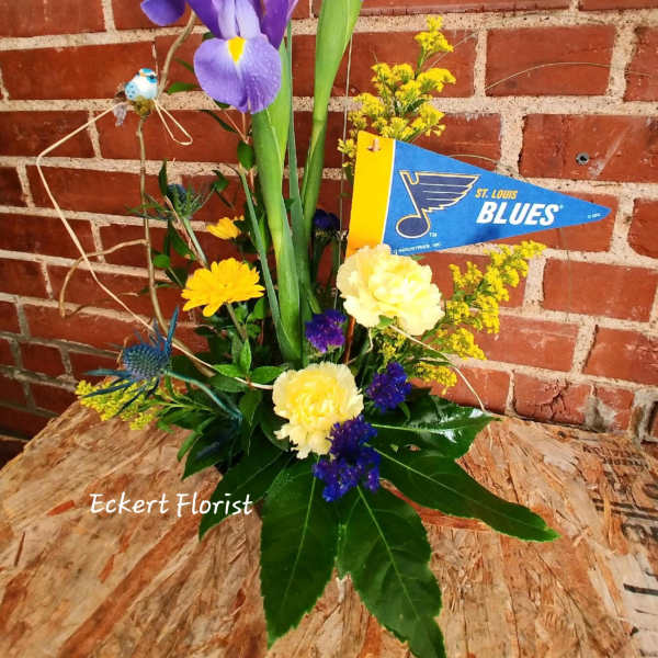 Purple irises with yellow and blue flowers in a low arrangement
