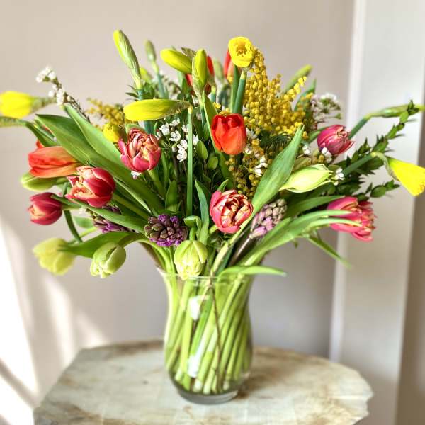 Colorful tulip bouquet in a clear glass vase