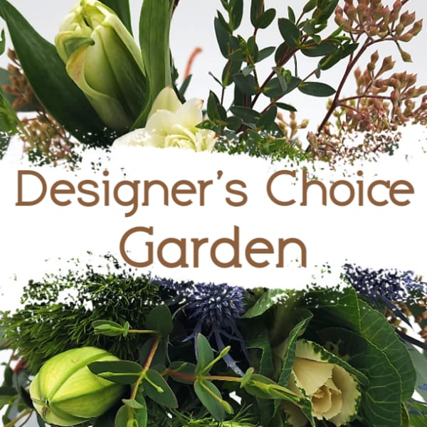 Garden-style floral arrangement with pale green blooms and dark foliage