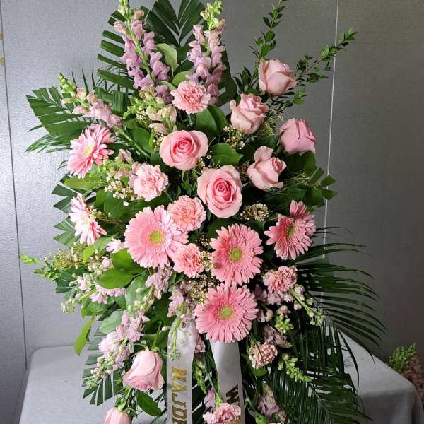 Large pink floral standing spray with roses and gerbera daisies