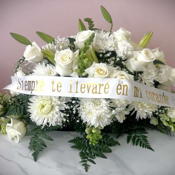 White rose and chrysanthemum arrangement with a memorial ribbon