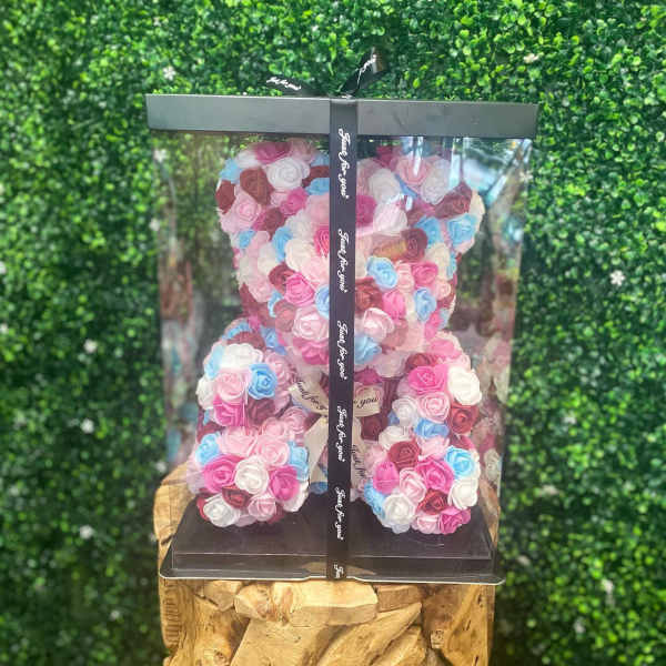 Teddy bear made of pastel roses in a clear gift box
