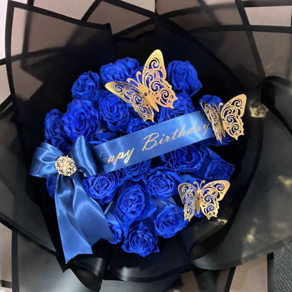 Blue rose bouquet with a birthday ribbon and butterfly decorations