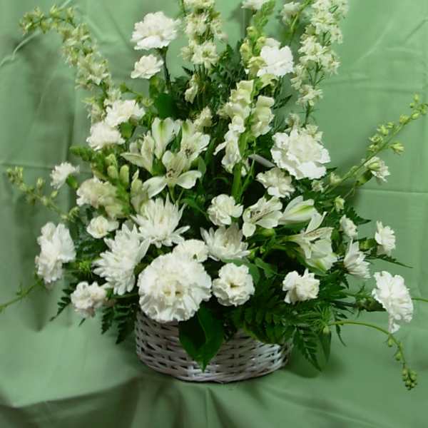 White floral arrangement in a wicker basket