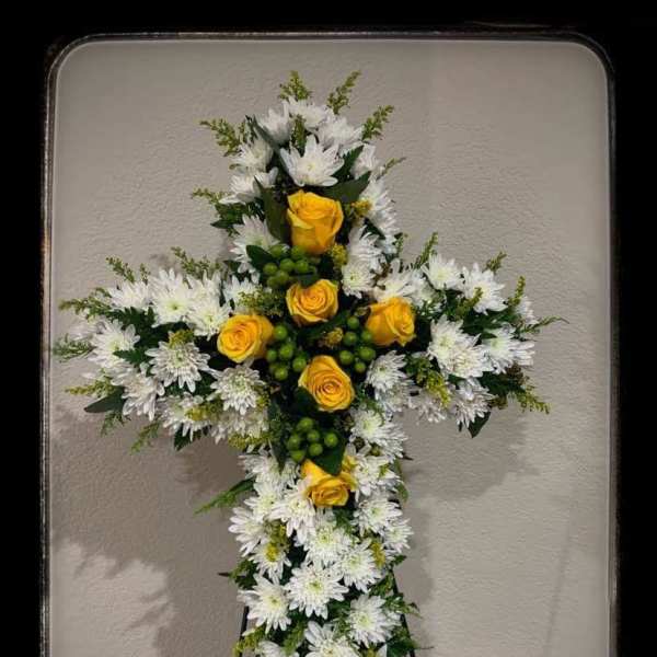 Cross-shaped floral standing spray with white daisies and yellow roses