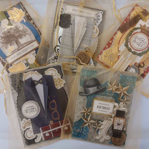 Five decorative birthday greeting cards tied in sheer ribbon.