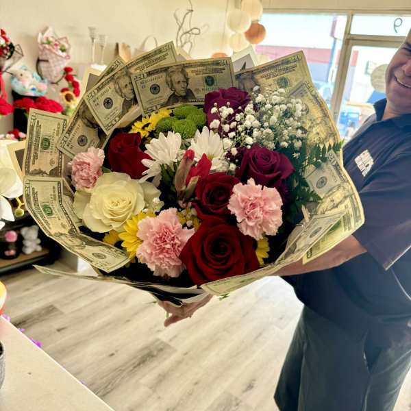Bouquet of mixed flowers wrapped with U.S. dollar bills