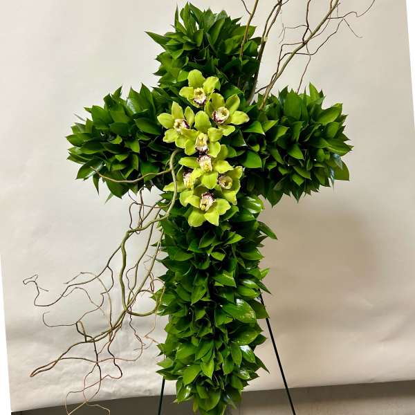 Green floral cross with orchids and twisting branches