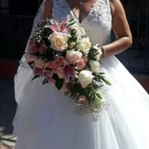Bride holding a cascading bouquet of pink and white flowers