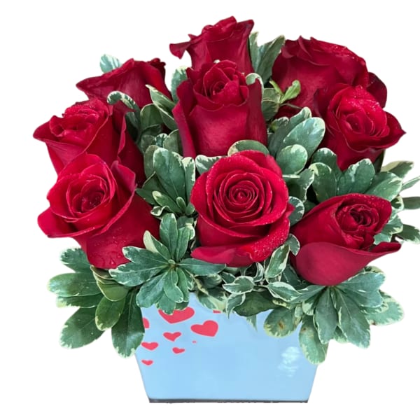 Red roses arranged in a blue heart-decorated container