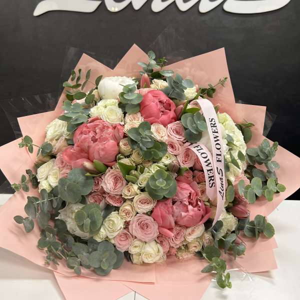 Large pink and white bouquet with eucalyptus and a ribbon