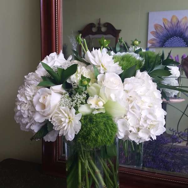 White floral arrangement in a clear glass vase