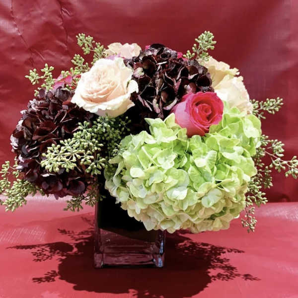 Custom Arrangement of Roses & Hydrangea in clear glass cube with leaf wrap