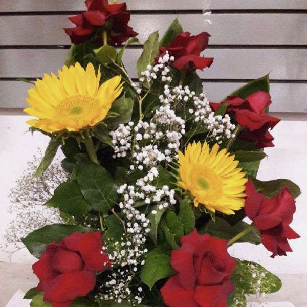 Bouquet of red roses, yellow daisies, and white baby's breath