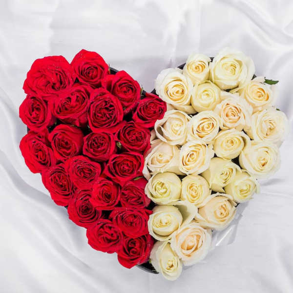 Heart-shaped arrangement of red and white roses
