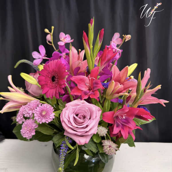 Pink and purple mixed bouquet in a glass vase