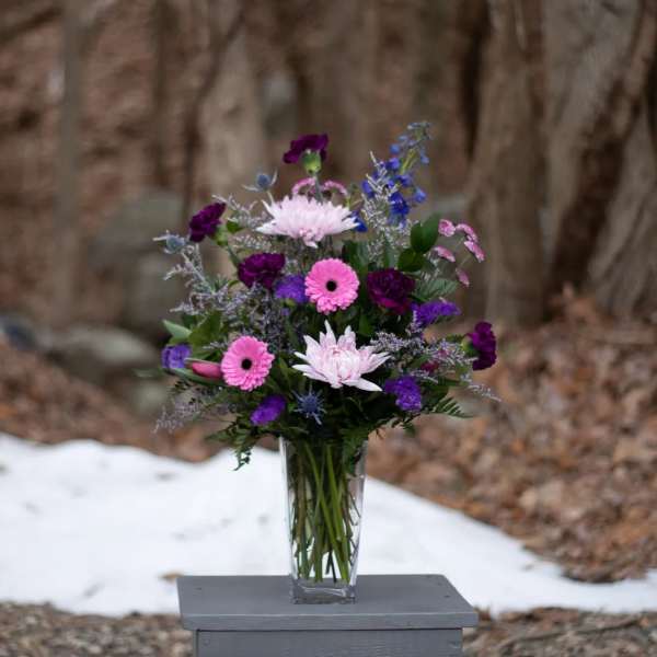Pink and purple mixed bouquet in a clear glass vase