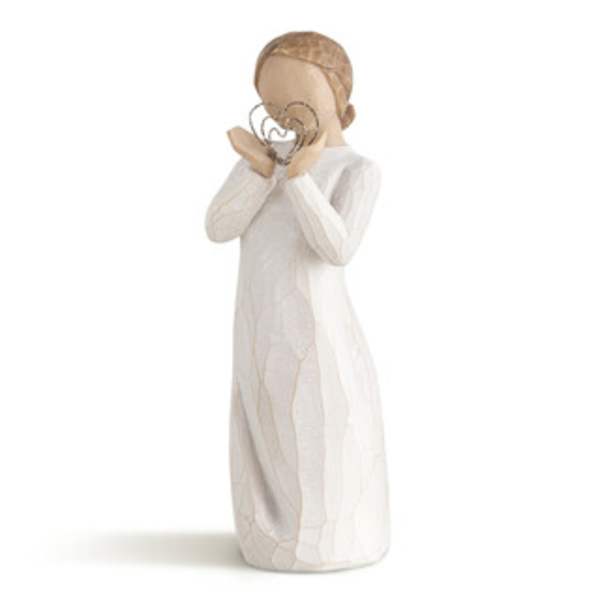 Wooden figurine of a girl holding a heart-shaped ornament