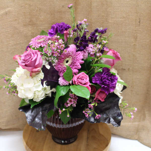 Pink and purple mixed bouquet in a glass vase