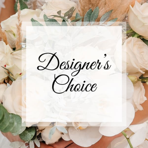 White floral arrangement with a "Designer’s Choice" sign