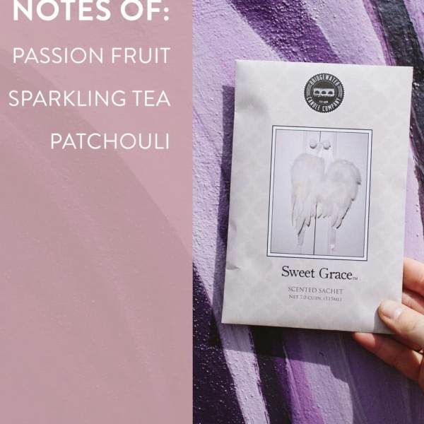 Hand holding a scented sachet package beside a pink note card