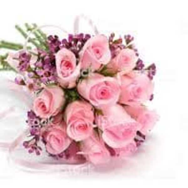 Bouquet of pink roses with purple filler flowers tied with a pink ribbon